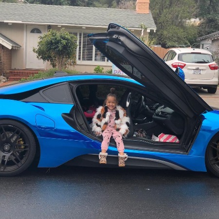 The picture of Khari Barbie Maxwell posing with a luxurious car. 